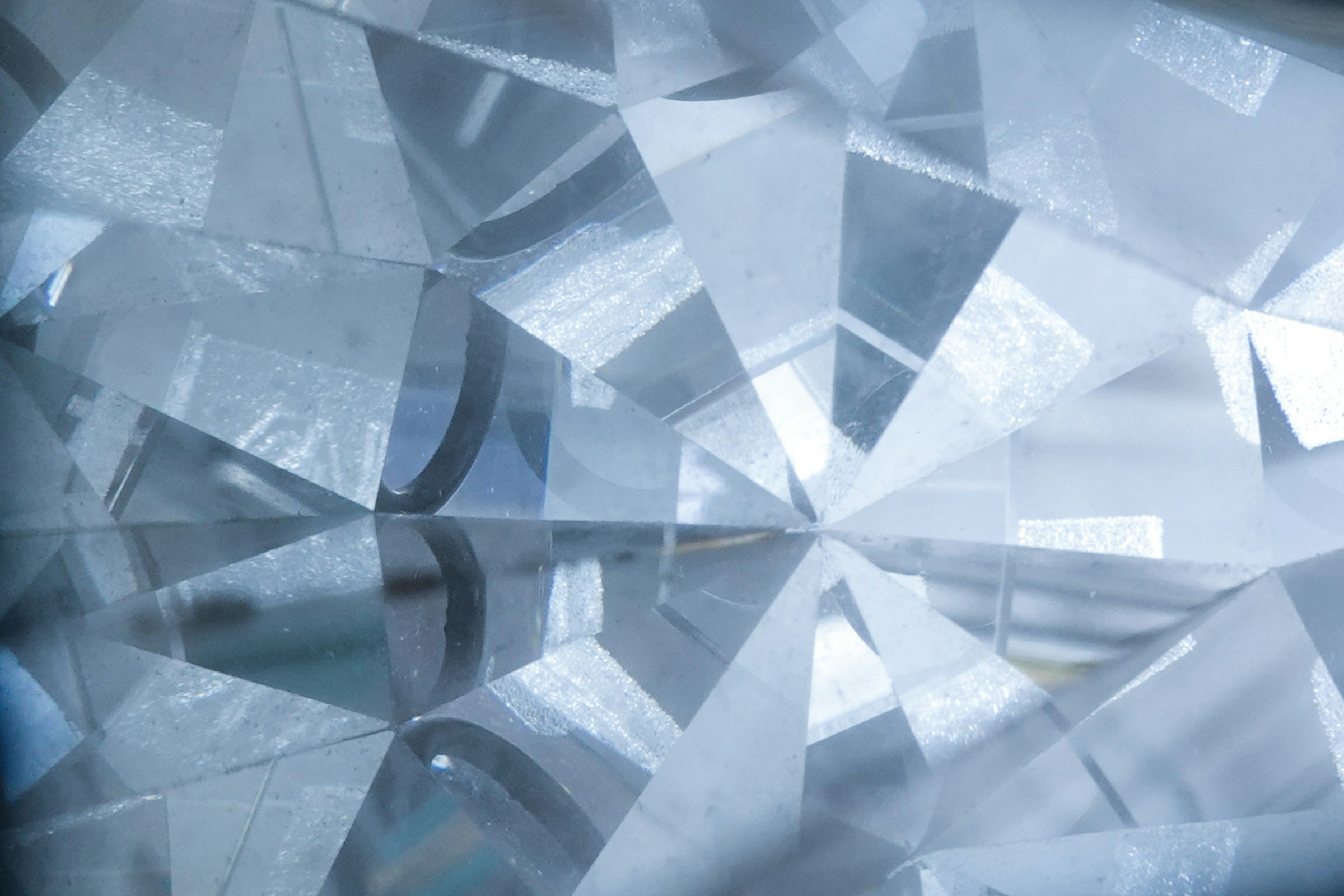 Macro view of a diamond's facets under light